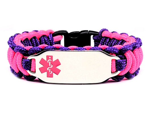 Pink & purple, thin, 275 paracord medical alert bracelet with a silver colored, stainless steel ID tag with an enameled pink medical symbol, displayed on a white background.