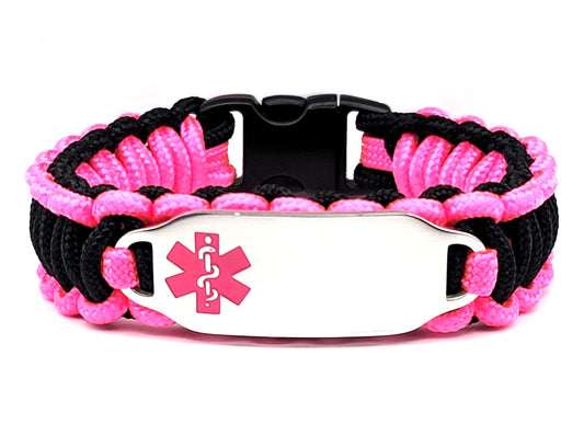 Pink & Black, thin, 275 paracord medical alert bracelet with a silver colored, stainless steel ID tag with an enameled pink medical symbol, displayed on a white background.