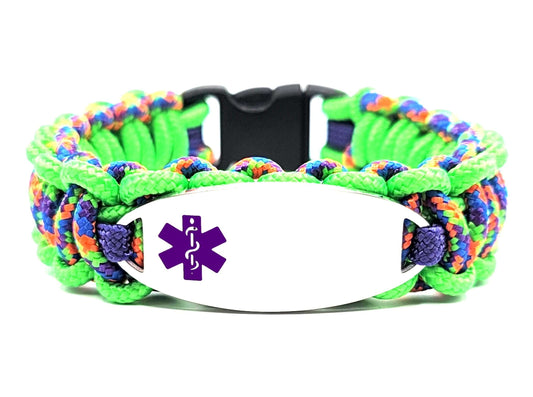 Brightly colored green and multicolored, thin, 275 paracord medical alert bracelet with a silver colored, stainless steel ID tag with an enameled purple medical symbol, displayed on white background.