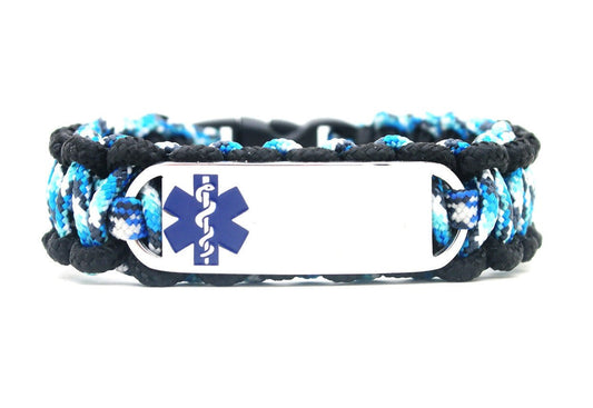 Blue and black, thin, 275 paracord medical alert bracelet with a silver colored, stainless steel ID tag with an enameled blue medical symbol, displayed on a white background.