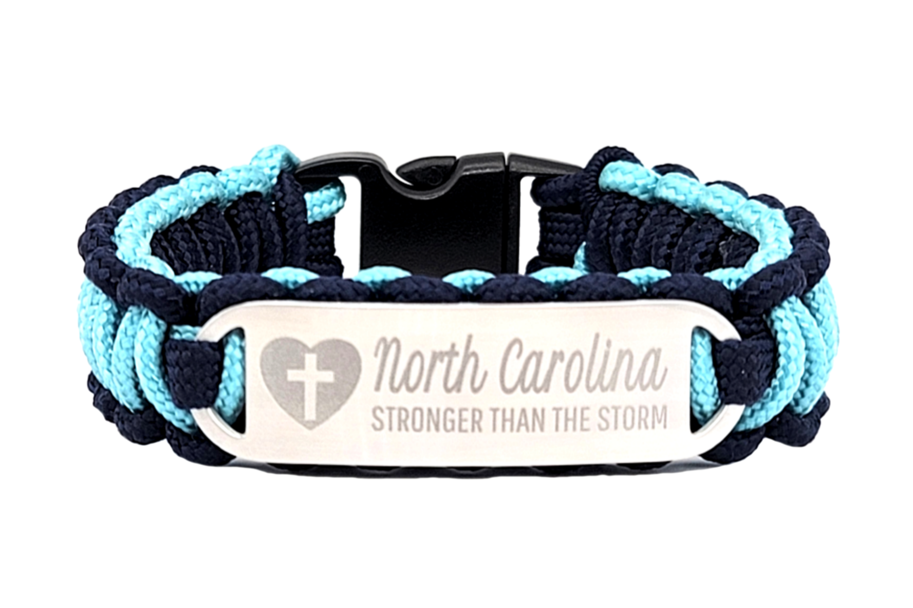 Navy blue and light blue thin 275 paracord ID bracelet with a silver, stainless steel ID tag engraved with North Carolina Stronger than the Storm and a cross in a heart symbol, displayed on a white background.