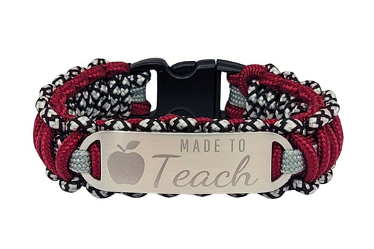A burgundy and silver thin 275 paracord ID bracelet with a silver, stainless steel ID tag engraved with Made to Teach and an apple symbol, displayed on a white background.