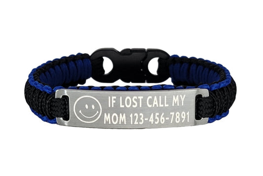 A front-facing view of a blue and black micro cord bracelet with an engraved metal tag that says If Lost Call My Mom and a phone number along with a smiley face symbol, displayed on a plain white background.