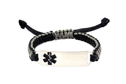 Adjustable micro paracord medical ID bracelet on a white background. Features a black and gray cord with a polished silver tag engraved with a black medical alert symbol, showcasing its durable design and customizable fit.