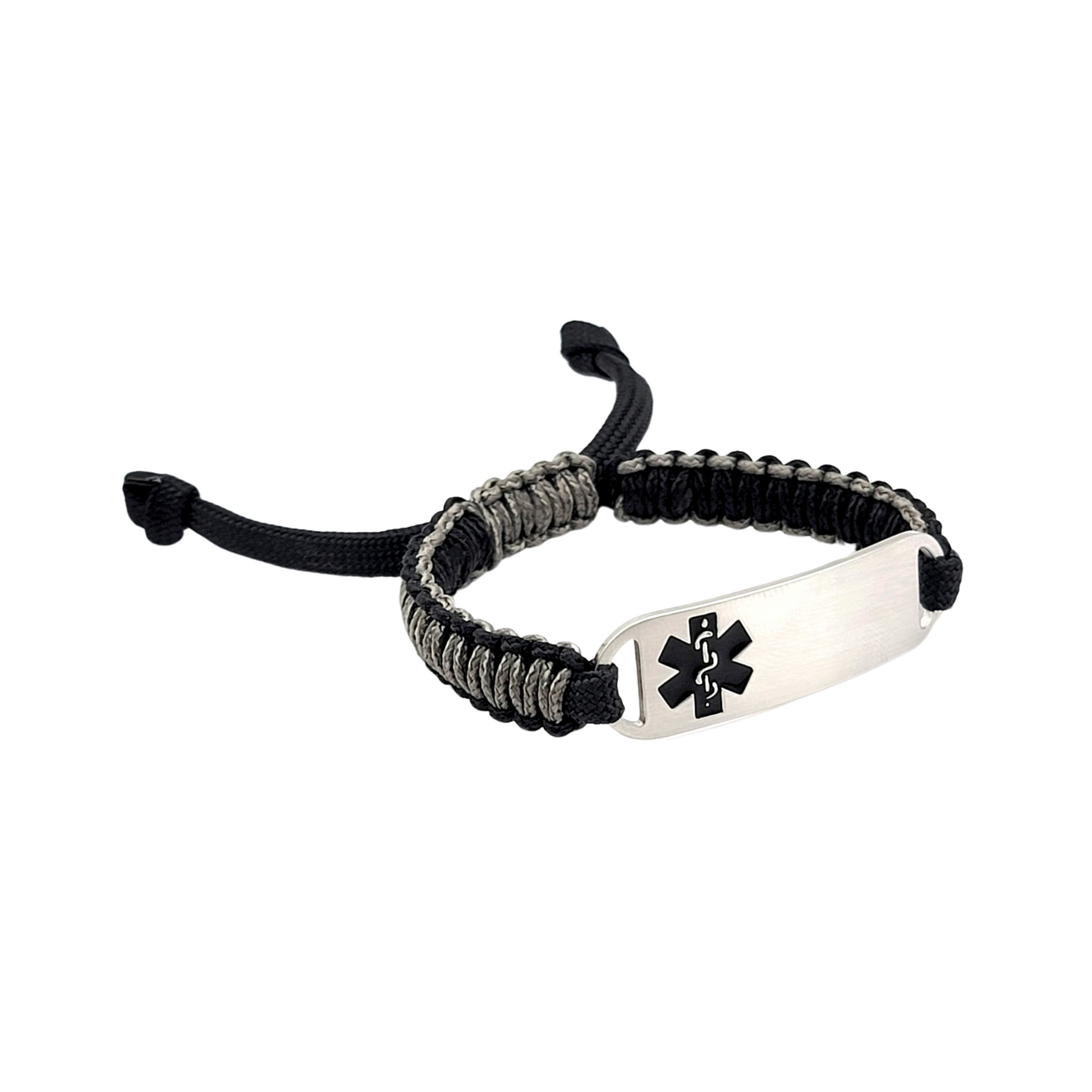 Side view of an adjustable micro paracord medical ID bracelet on a white background. Features a black and gray cord with a polished silver tag engraved with a black medical alert symbol, showcasing its durable design and customizable fit.