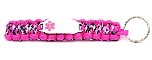 Brightly colored pink paracord medical ID keychain with a silver, stainless steel ID tag with a pink enameled medical symbol, displayed on a white background.
