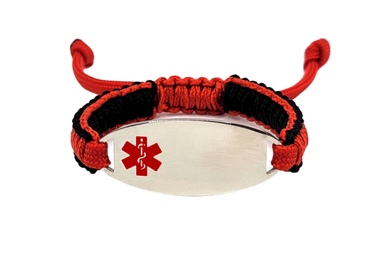 An adjustable micro paracord bracelet displayed on a white background. The bracelet features a polished silver oval tag engraved with a red medical alert symbol, and the paracord is woven in red and black.