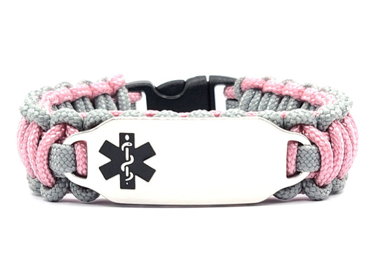 Pink & grey, thin, 275 paracord medical alert bracelet with a silver colored, stainless steel ID tag with an enameled black medical symbol, displayed on a white background.