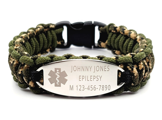 Camouflage thin 275 paracord ID bracelet with a silver, stainless steel ID tag engraved with medical information and a medical symbol, displayed on a white background.