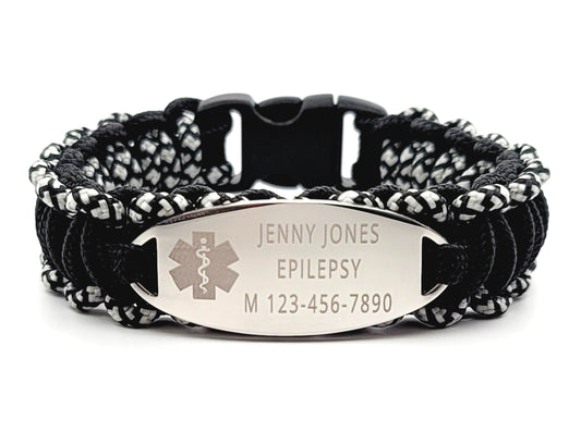 Black & Silver thin 275 paracord ID bracelet with a silver, stainless steel ID tag engraved with medical information and a medical symbol, displayed on a white background.