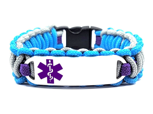 Blue, grey & purple, thin, 275 paracord medical alert bracelet with a silver colored, stainless steel ID tag with an enameled purple medical symbol, displayed on white background.