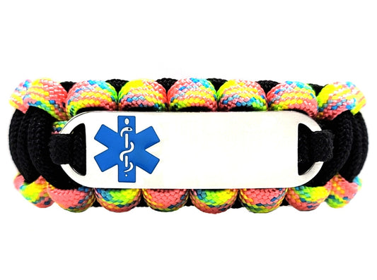 Black and fairy tale colored paracord medical alert bracelet with a silver colored, stainless steel ID tag with an enameled blue medical symbol, displayed on a white background.
