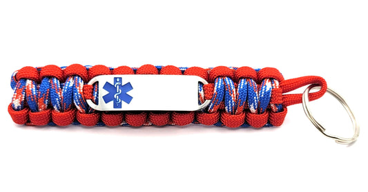 Patriotic red, white, and blue paracord medical ID keychain with a silver, stainless steel ID tag with a blue enameled medical symbol, displayed on a white background.
