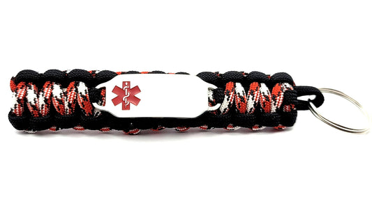 Black red and white paracord medical ID keychain with a silver, stainless steel ID tag with a red enameled medical symbol, displayed on a white background.